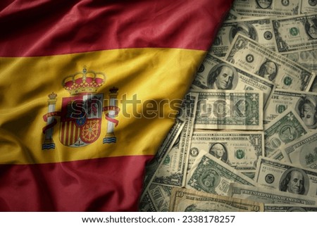 big colorful waving national flag of spain on a american dollar money background. finance concept