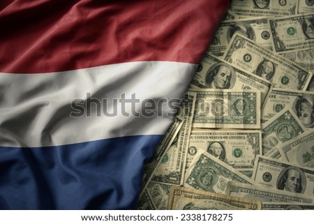 big colorful waving national flag of netherlands on a american dollar money background. finance concept