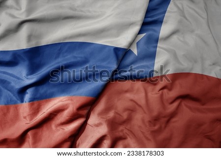 big waving realistic national colorful flag of russia and national flag of chile . macro