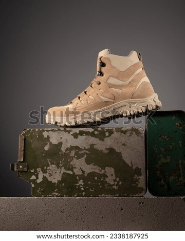 Modern practical military shoes with military accessories. Poster for advertising 