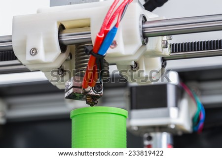 3d printer with bright green filament. Royalty-Free Stock Photo #233819422