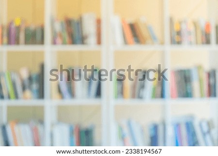 Abstract blurred white bookshelves with books  on bookshelves in library, book store, for backdrop. Concept for education, literature