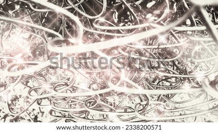 The silver wire coiled into rolls, reflecting white light as a shimmering display.
