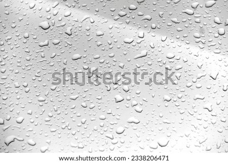 a photography of a close up of a rain covered window, a close up of a rain covered window with water droplets.