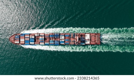 cargo container ship sailing full speed in sea to import export goods and distributing products to dealer and consumers worldwide, by container ship Transport business delivery service, aerial view Royalty-Free Stock Photo #2338214365