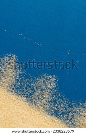 Close up of sand grains and copy space on blue background. Sand, texture, shape and colour concept.