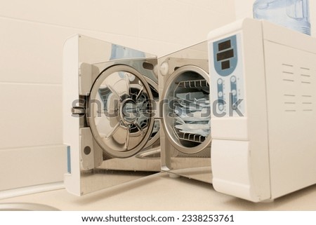 Sterilizing medical instruments in autoclave. Dental office. Selective focus. Sterile dental tools Royalty-Free Stock Photo #2338253761