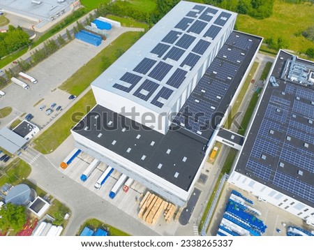 Aerial view of distribution center, drone photo of industrial logistics zone,new super modern logistics center full of modern technology and robotics,roof solar power plant for green energy production