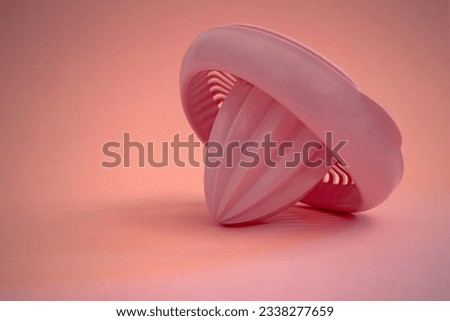 Plastic pink lemon juicer on isolated pastel pink background