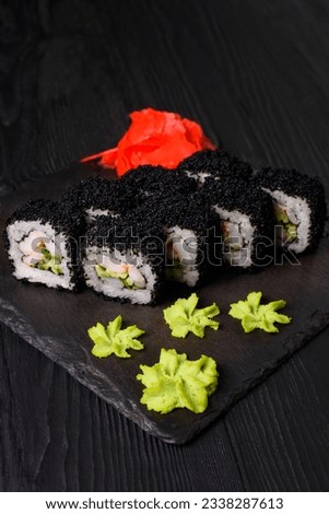 japanese cuisine, california rolls with shrimp on a black background