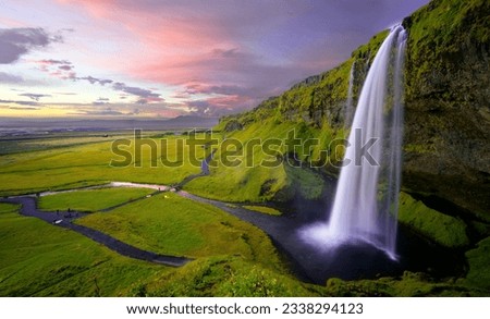 The background is amazing beautiful greenery trees and the sky is fabulous the waterfall is giving the grace.