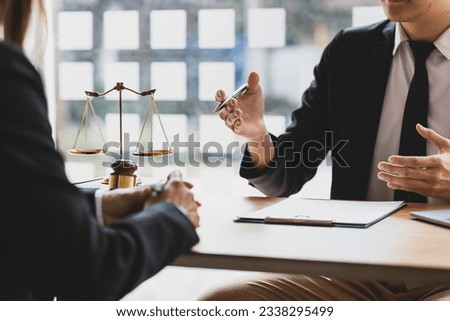 Lawyer is explaining the terms of the legal contract document and asking the client to sign it properly. Legal counsel and legal proceedings consulting services. Royalty-Free Stock Photo #2338295499