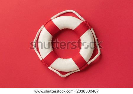 Lifebuoy on a red background, top view Royalty-Free Stock Photo #2338300407