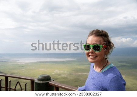 Tourist woman poses at the overlook of the Ngorongoro Crater Tanzania
