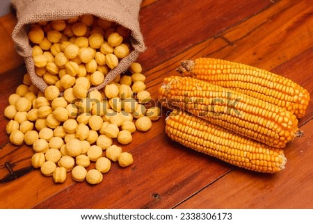 corn, round corn snacks, in a linen bag, on a wooden background, generated with an extruder machine