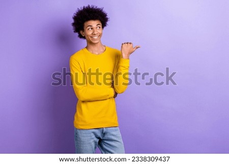 Portrait of positive young person look indicate thumb finger empty space proposition isolated on purple color background