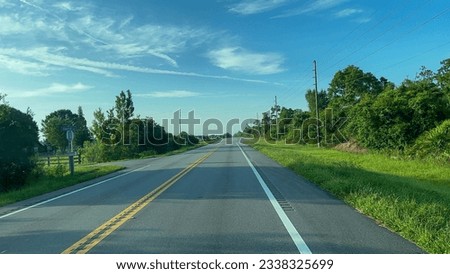 Driving through the Florida countryside on Highway 441 on a sunny day. Royalty-Free Stock Photo #2338325699