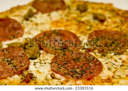 A fresh, hot, spicy pepperoni and sausage pizza