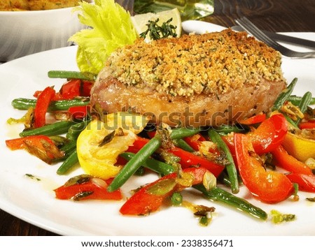 Grilled Pork Loin Steak with a Classic Breadcrumb, Garlic and Herb Crust Royalty-Free Stock Photo #2338356471