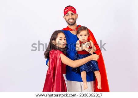 portrait of father and his daughters dressed in hero costumes on white background with space for text. Father's Day.