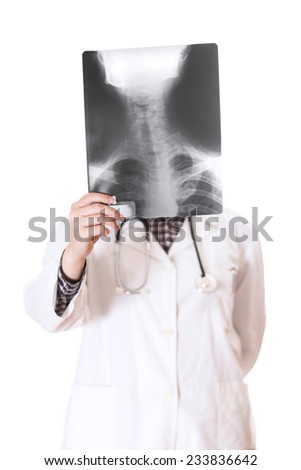 Young female doctor looking at the x-ray picture of cervical spine in a hospital