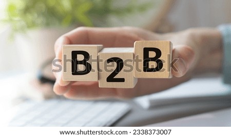 Acronym B2B- Business to Business. hand holding wood cube block with b2b text. Business Concept image. Royalty-Free Stock Photo #2338373007