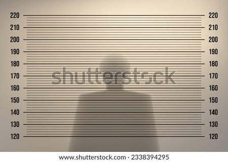 Mugshot in a police station with a retro background with backlight on an old wall and the shadow of a man. Height identification with measurement line in the examination room. Vintage vector template Royalty-Free Stock Photo #2338394295