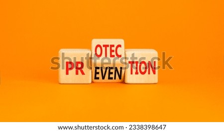 Protection and prevention symbol. Concept word Protection Prevention on wooden cubes. Beautiful orange table orange background. Business protection prevention concept. Copy space. Royalty-Free Stock Photo #2338398647
