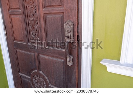 Antique door handle with old wooden door.