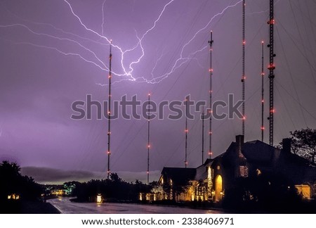 Big lightning bolts over houses and radio towers in Austin Texas