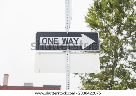 one-way sign on a city street, symbolizing direction, restriction, and adherence to a predefined path in life. Decisions and choices
