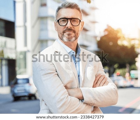 Arms crossed, portrait and business man in city for professional, executive and corporate. Ceo, manager and mission with mature person in street in New York for pride, confidence and entrepreneur
