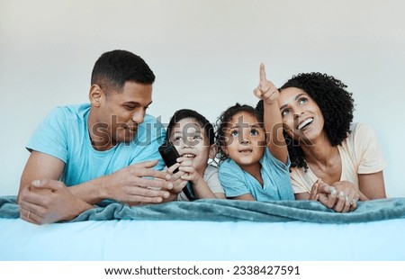 Father, mom and kids on bed, watching tv and smile for comedy, funny movie or pointing in family home. Happy parents, children and watch television show with streaming, subscription or laugh together