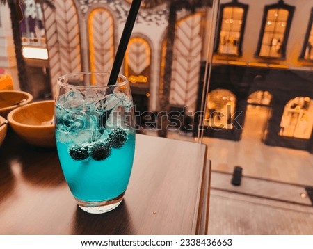 blue drink with crushed ice . ice and fresh berry. Summer refreshing drink