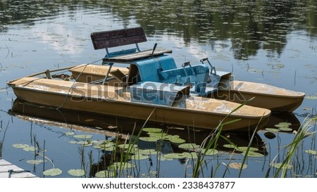 An old catamaran is standing on the water. Background picture.