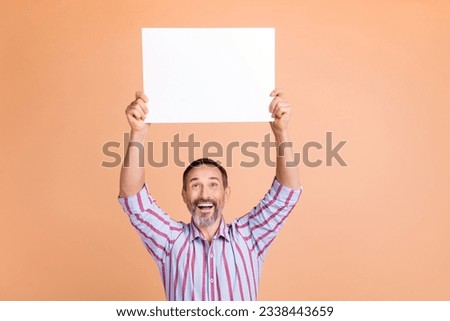 Portrait of astonished impressed person with gray beard wear stylish shirt look at placard over head isolated on pastel color background