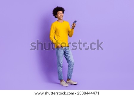 Full body size photo of satisfied guy enjoy shopping stores online discount message texting hold iphone isolated on violet color background