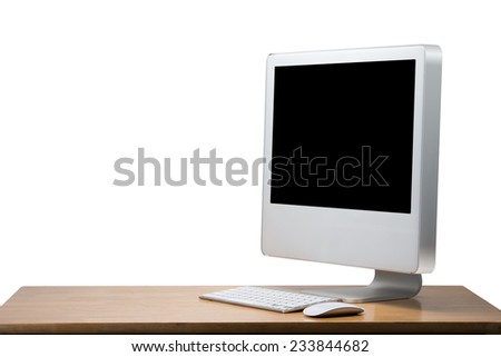 Computer display with wireless keyboard and mouse on wooden table. Isolated on white background with clipping path