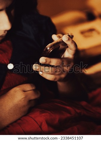 Cell phone games playing  by Indian ethnic girl child- low light edit - selective focus
