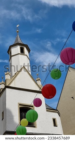 multi-colored paper balls, street decoration, festive city decor, street in summer, balls in the wind, exterior, in the city in summer, july