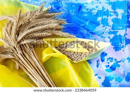 Ukrainian flag grain wheat and spikelets on dark background. Ukraine Russia conflict, Grain deal and problem of blockade of ports, grain corridor Royalty-Free Stock Photo #2338464059