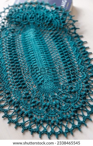 Teal blue crochet doily. This photo has been taken in Prague, 2023