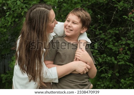 mother and son deeply engaged in a lighthearted conversation, encapsulating the simplicity of familial happiness Royalty-Free Stock Photo #2338470939