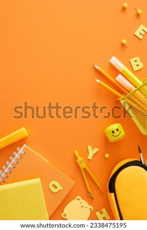New school year concept. Top view vertical photo of assorted school materials, yellow letters on orange background with blank space for advert or text Royalty-Free Stock Photo #2338475195