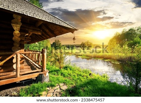 Wooden bathhouse near lake at the sunset