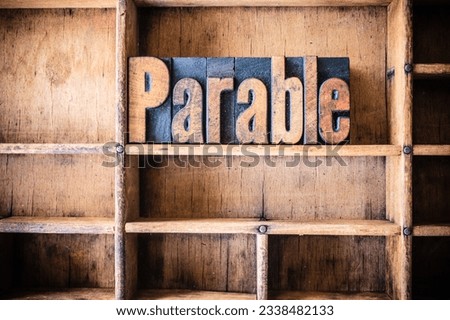 The word PARABLE written in vintage wooden letterpress type in a wooden type drawer.