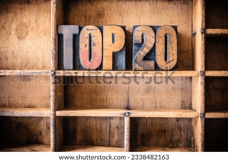 The word TOP 20 written in vintage wooden letterpress type in a wooden type drawer.