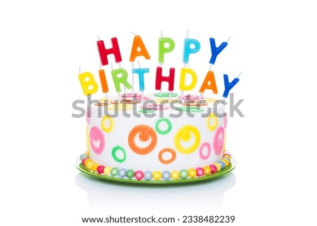 happy birthday cake or tart with happy birthday letters as candles very colorful and looking very tasty, isolated on white background
