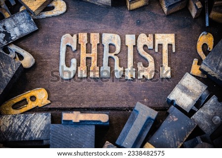 The word CHRIST written in rusted metal letters surrounded by vintage wooden and metal letterpress type.