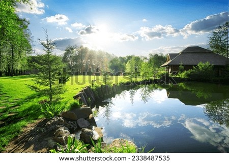 Wooden bathhouse near lake in the evening